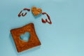 Love and Freedom Concept. Flat Lay of Sliced Toasted Bread in Shape of Heart and Wings Drawn by Tomato Sauce