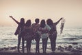 Love friendship and celebration time concept image with group of women friends viewed from back enjoying the beautiful coloured