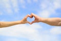 Love, friendship concept. Girl and male hand in heart form love blue sky. Female and man hands in the form of heart Royalty Free Stock Photo