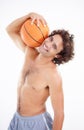 For the love of the game. Portrait of a sexy young man holding a basketball on a white background. Royalty Free Stock Photo