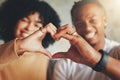 Love is the golden link which binds us. Closeup shot of a young couple making a heart shape with their hands.