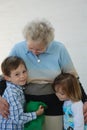 Grandma is the best. Grandchildren and her great grandma Royalty Free Stock Photo