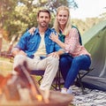 We love the great outdoors. Portrait of an affectionate couple camping out in the woods. Royalty Free Stock Photo