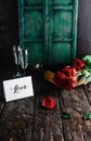 Love greeting card, red roses and champagne bottle with glasses on shabby wooden table, valentines Royalty Free Stock Photo