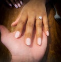 Love hands of an ethnic black and White couple during Valentine& x27;s day in a restaurant.  Ring would you like to marry me ? Royalty Free Stock Photo