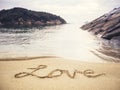 Love handwriting on Sand Beach Holiday background