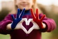 Love and happiness concept. Cute child forming heart gesture with hands outdoors on nature sunset background. Heart Royalty Free Stock Photo