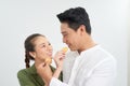 Love and happiness. Cute lovely lovers feeding each other by cupcakes cookies