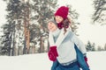 Love - Happy couple having fun smiling laughing together on romantic holidays. Young man giving piggyback ride to his girlfriend o Royalty Free Stock Photo