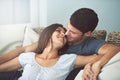 Love, happy and couple relaxing on sofa in living room cuddling and bonding for marriage at home. Smile, romance and Royalty Free Stock Photo