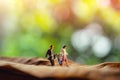 Love and Happy Family. Work Life Balance Concept. Miniature of Father, Mother and Son holding Hands and Walking on Dry Leaf Royalty Free Stock Photo
