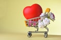 Love and happy Valentine`s day roses colorful and red heart symbol in shopping cart