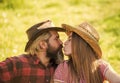 Love and harmony. Bearded cowboy in hat kissing adorable girlfriend. Couple in love. Romantic kiss. Happy couple ranch