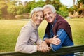 Love has no age. Portrait of a happy senior couple sitting on a park bench. Royalty Free Stock Photo