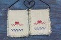 Love heart icon on fabric hanging on hanger in old wooden background