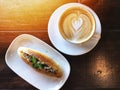 Love heart Latte art coffee in white cup and bread Royalty Free Stock Photo