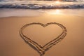 Love: heart on the sand on a beach, tropical ocean sunset. Royalty Free Stock Photo