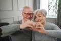 Love heart shape peace. Senior older couple making heart shape with their hands. Adult mature old husband wife showing