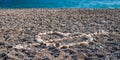 Love heart shape on sand made out of white pebbles, symbol of love on the beach with sea background. Valentine day Royalty Free Stock Photo