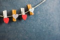 Love Hearts clothespins or pegs on a rope on wooden rustic vintage background