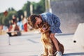 In love with her pet. Cute little girl have a walk with her dog outdoors at sunny day Royalty Free Stock Photo