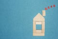 Love in home concept. Wooden house and red hearts from chimney pipe on blue background Royalty Free Stock Photo