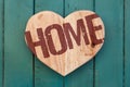 Love home message wooden heart on turquoise painted background