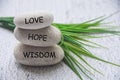 Love, hope and wisdom text engraved on zen stones Royalty Free Stock Photo