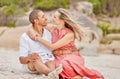 Love, hug and couple on the beach look into eyes and relax outdoor together on sand or ground. Happy interracial black Royalty Free Stock Photo