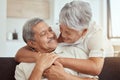 Love, hug and elderly couple on a sofa, happy and relax, laughing and talking their home together. Embrace, smile and Royalty Free Stock Photo