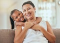 Love, hug and grandmother portrait with granddaughter bonding at home on the living room sofa. Mature woman embracing Royalty Free Stock Photo