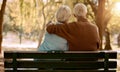 Love, hug and old couple in a park on a bench for a calm, peaceful or romantic summer marriage anniversary date. Nature Royalty Free Stock Photo