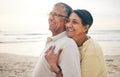 Love, hug and senior couple at beach happy, relax and bond in nature together. Ocean, embrace and old people hugging at