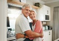 Love, hug and senior couple in the kitchen cooking dinner in a happy home enjoying retirement together at home. Romance Royalty Free Stock Photo