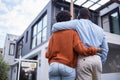 Love, hugging and back of couple by their new home, property or real estate standing together. Relocation, romance and Royalty Free Stock Photo