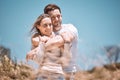 In love, hugging and relaxing young couple happy, smiling on an outdoors vacation getaway. Romantic couple relax outside Royalty Free Stock Photo