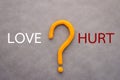 Love and hurt concept with text and question mark Royalty Free Stock Photo