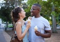 Love, ice cream or couple of friends hug in a park on a romantic date in nature in an interracial relationship. Bonding Royalty Free Stock Photo