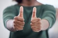 Love it, keep it up. an unrecognisable businesswoman showing thumbs in a modern office. Royalty Free Stock Photo