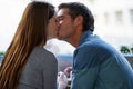 Love, kiss and couple in coffee shop, cafe and bonding to relax together on valentines day date. Romance, man and woman Royalty Free Stock Photo