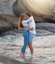Love, kiss and happy with couple at beach for romance, relax and vacation trip. Travel, sweet and cute relationship with Royalty Free Stock Photo