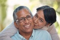 Love, kiss and happy senior couple sharing commitment, hug and affection while sitting together showing smile. Portrait Royalty Free Stock Photo