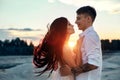 Love kiss and hugs in love couples at sunset in the evening sun, a walk through the mountains and hills. Sensual and gentle loving Royalty Free Stock Photo