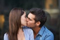 Love, kiss and a young couple outdoor for care, commitment and people in connection. Romance, man and woman touch lips Royalty Free Stock Photo