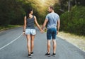 Love knows the way. a happy young couple walking down a road outside. Royalty Free Stock Photo