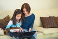 Love, laptop and mother with her kid on a sofa browsing on social media while bonding together. Happy, smile and young Royalty Free Stock Photo