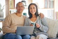 Love, laptop and portrait of couple relax on living room sofa, drinking coffee and working from home. Digital computer Royalty Free Stock Photo