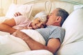 The love that lasted a lifetime. a senior couple being affectionate in their bedroom.