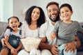 Love, laugh and watching tv or a movie with a happy family eating popcorn, having fun and smile together in home Royalty Free Stock Photo