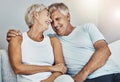 Love, laughing and retirement with a senior couple sitting in the living room of their home together. Happy, smile or Royalty Free Stock Photo